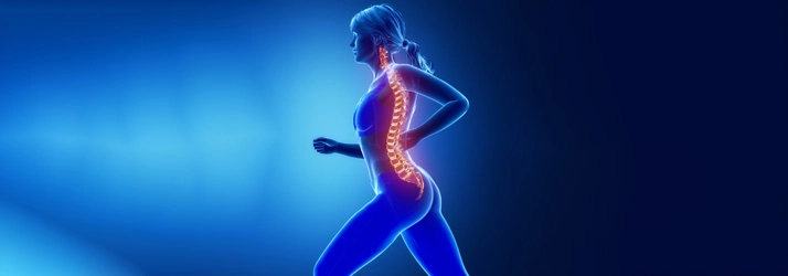 A side view of a running person with the spine highlighted in bright colors against a blue background, illustrating spinal alignment and movement.
